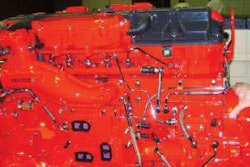 All Cummins ISX engines have the XPI common-rail injection system, which uses a crankshaft-driven pump to keep the fuel rail – seen of the left side of this 11.9L ISX – pressurized to more than 30,000 psi, providing full injection pressure to solenoid-activated injection nozzles in the head. Such systems provide maximum injection pressure even at low rpm and eliminate the need to adjust the injector rockers when doing overheads.