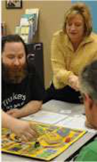 During orientation, Charlotte Eckley, O&S Trucking’s chief operating officer, coaches owner-operators on how to play the business skills board game she created.