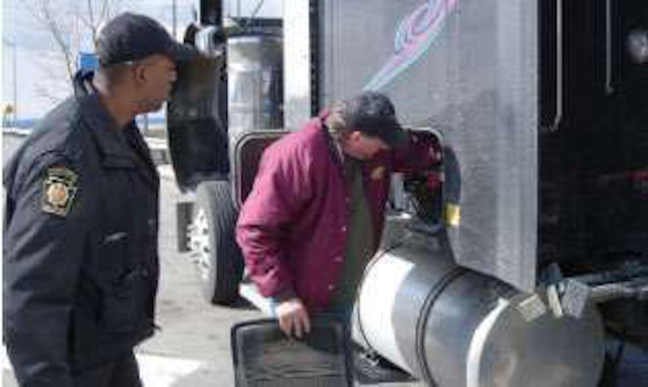 Here, Hodges asks the driver to open the storage compartment. One part of an inspection is checking for the required onboard safety equipment, which includes items such as a fire extinguisher and reflectors.