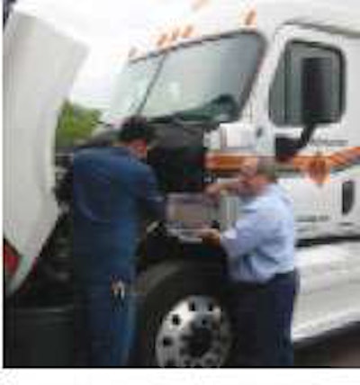 Wayne Beaudry, vice president of fleet maintenance for Maywood, N.J.-based Metropolitan Trucking, instructs a technician on parameter settings for a 2008 CARB-certified Detroit Diesel DD15 engine on a 2009 Freightliner Cascadia.