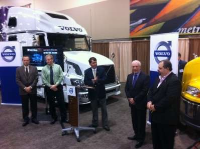 Ron Huibers, Volvo Trucks' senior vice president of sales and marketing (middle), honors representatives of Upper Lakes Foods and MacKinnon Transport with the Volvo Trucks Safety Award.