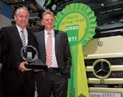 Andreas Renschler (right), member of Daimler’s board of management and head of Daimler Trucks and Daimler Buses, and Hubertus Troska, head of Mercedes-Benz Trucks, pose with the Mercedes-Benz Atego, which along with its BlueTec Hybrid version was recognized as Truck of the Year 2011 at the IAA Commercial Vehicles show in Hanover, Germany.