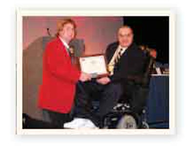 Tapp receives his Silver Spark Plug Award from Steph Sabo, 2010 TMC chairman.