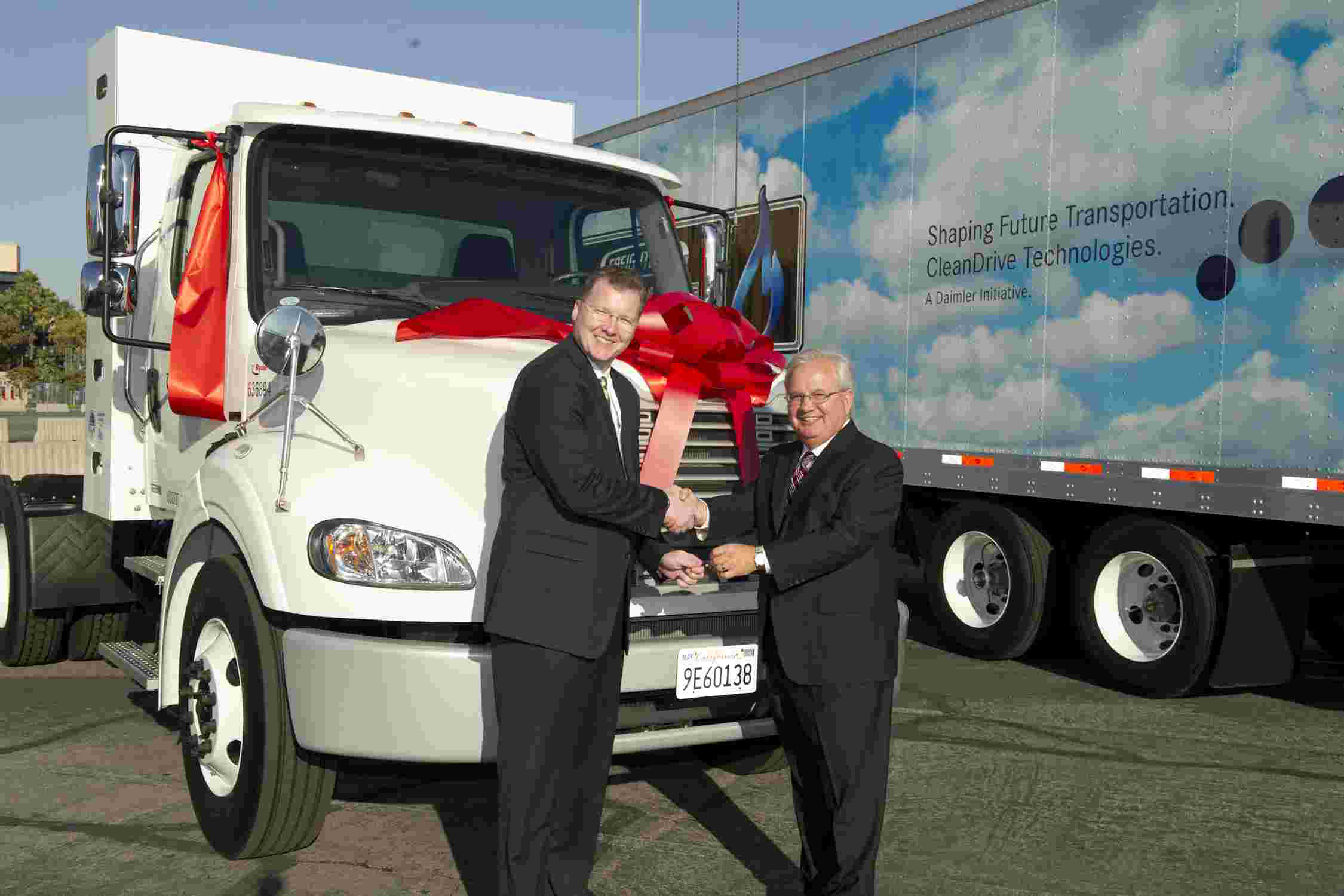 Fleet executives in front of a parked semi truck