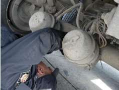 The landing gear and reefer fuel tank and lines get a careful look-see to make sure all is secure.