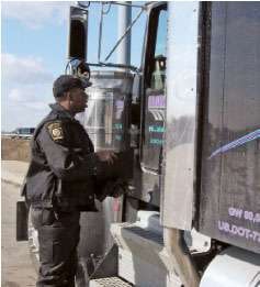 Here, Hodges asks the driver to open the storage compartment. One part of an inspection is checking for the required onboard safety equipment, which includes items such as a fire extinguisher and reflectors.
