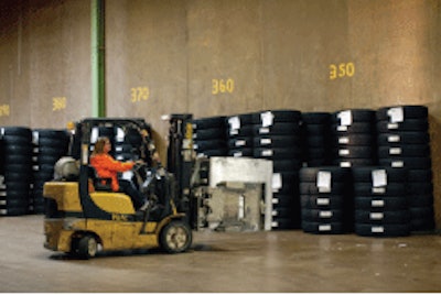 A worker at Continental’s truck tire plant in Mt. Vernon, Ill., loads finished tires for transport.