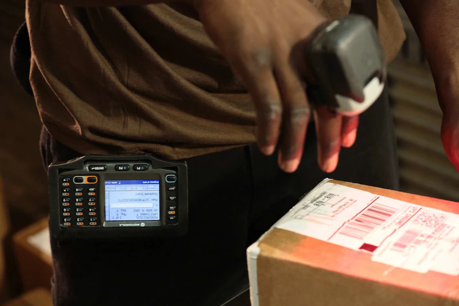 UPS employee scanning a package at a service counter