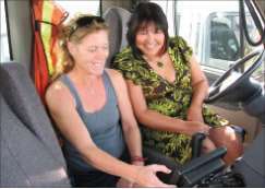 Dorothy Vankoughnett, IT manager and controller for Berry & Smith Trucking, reviews ECM data with Dina Elder, the company’s safety/driver liaison.