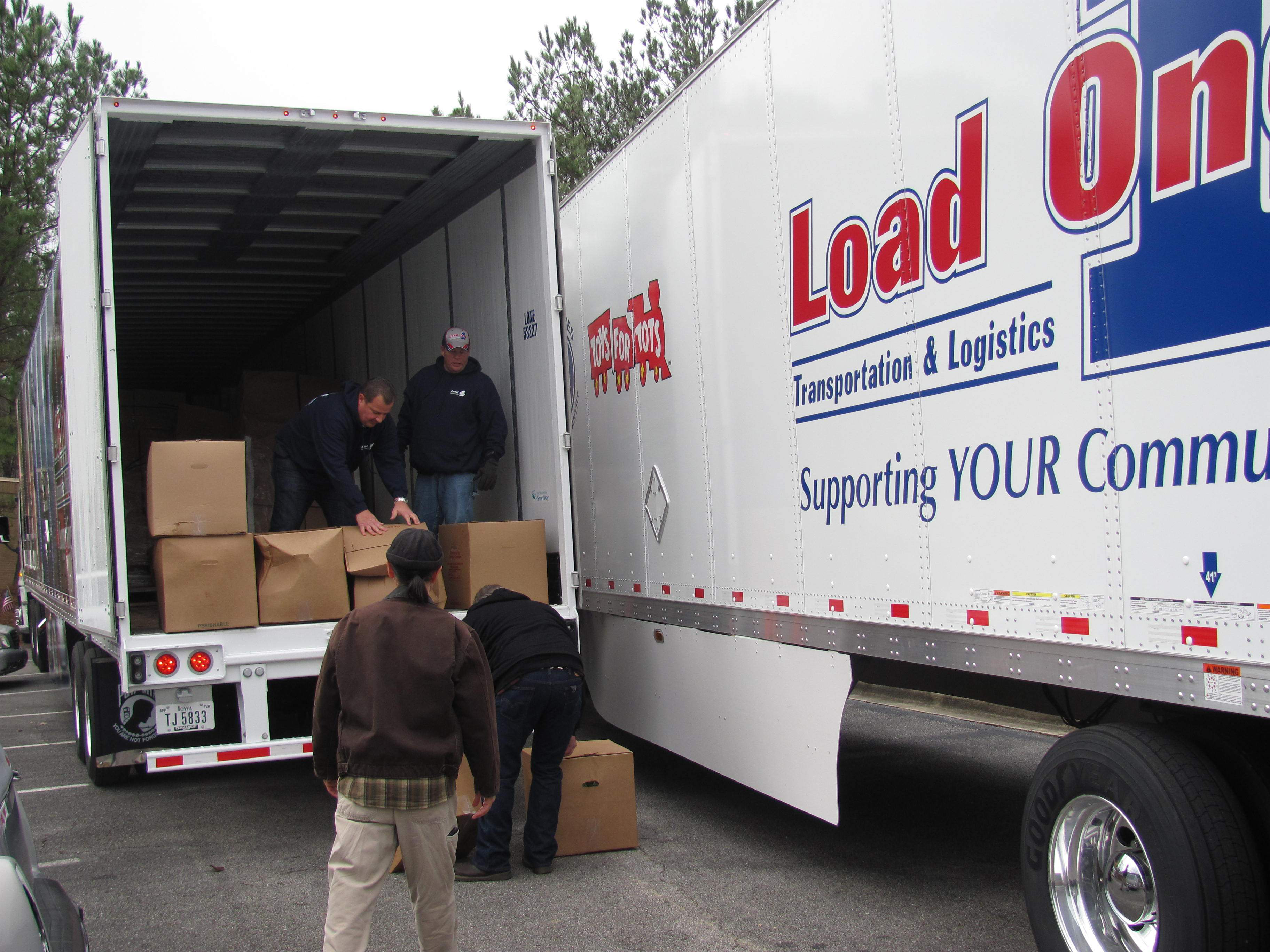 Load One Trucks And People Unloading Them