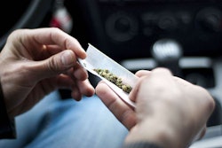 Person rolling marijuana in paper