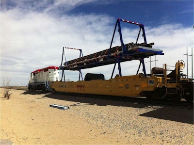 The two hydraulic gantry arms on either end of the deck allow the flatbed to function just like any other container, with the ability to double-stack loads.