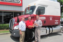 Dale Williams, center, a driver-instructor for Trimac Transportation and a 2013-14 ATA America’s Road Team Captain, gets the keys to his new 2014 Freightliner Cascadia from Josh Wood, left, general sales manager for Birmingham Freightliner, and Mike Thompson, the dealership’s general manager.