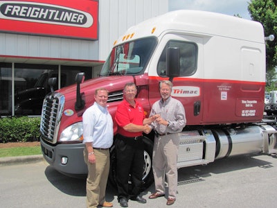 Dale Williams, center, a driver-instructor for Trimac Transportation and a 2013-14 ATA America’s Road Team Captain, gets the keys to his new 2014 Freightliner Cascadia from Josh Wood, left, general sales manager for Birmingham Freightliner, and Mike Thompson, the dealership’s general manager.