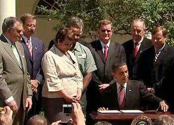 Trucking industry representatives and Cabinet officials join President Obama at the White House in 2011 as he signs the first-ever fuel efficiency standards for heavy-duty vehicles. (White House photo)