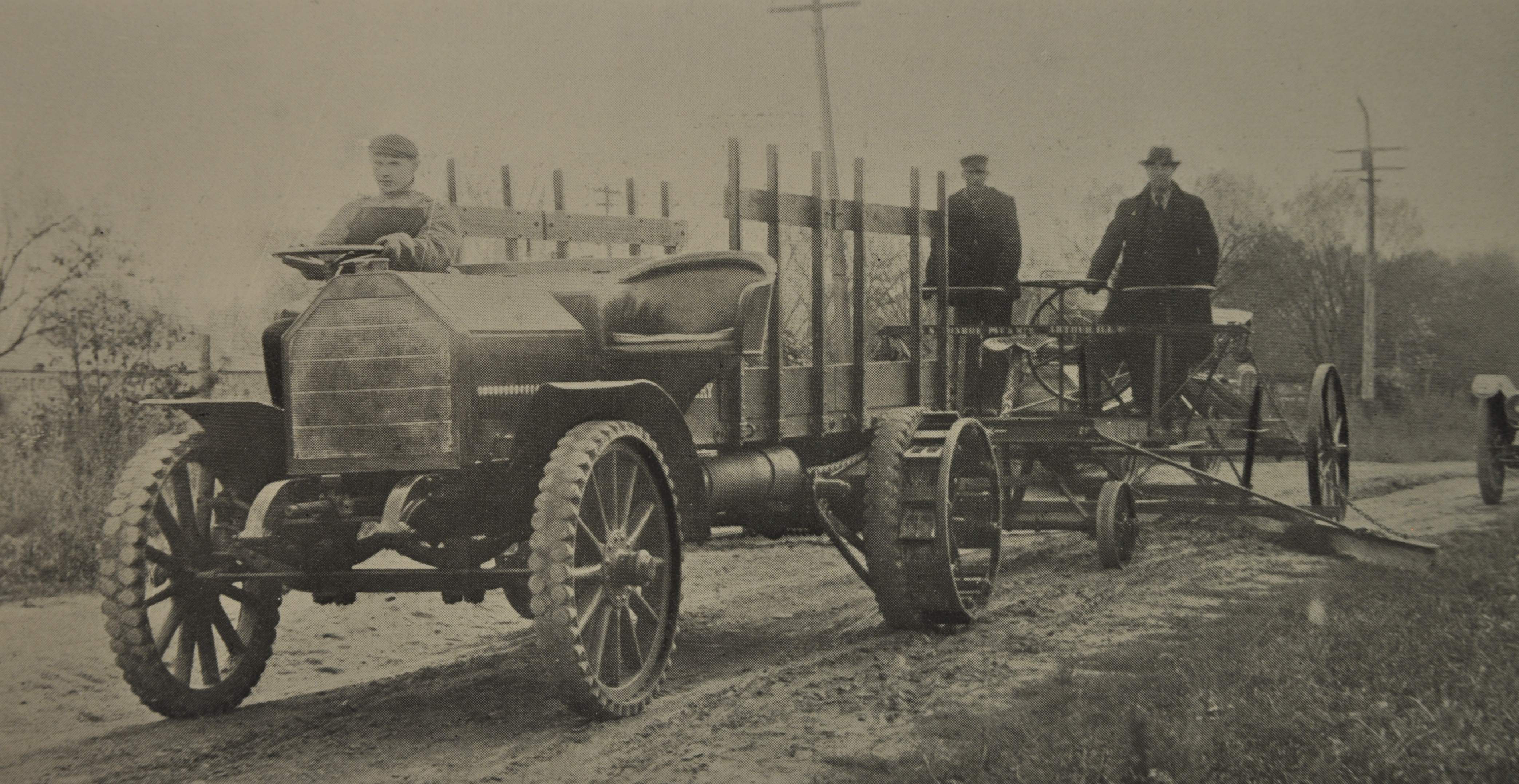 Construction was a natural fit for early trucks. And, symbiotically, so was building roads for the new-fangled vehicles to drive on. Here, an early truck pulls a grader. Note the ad hoc nature of the truck: right-hand steer, plush seating, a stake body and ag-tractor style iron wheels in the rear. That&rsquo;s not the most ergonomic steering wheel arrangement you&rsquo;ll ever see, either.