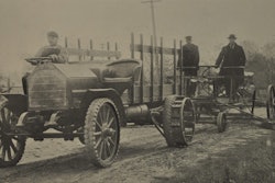 Construction was a natural fit for early trucks. And, symbiotically, so was building roads for the new-fangled vehicles to drive on. Here, an early truck pulls a grader. Note the ad hoc nature of the truck: right-hand steer, plush seating, a stake body and ag-tractor style iron wheels in the rear. That’s not the most ergonomic steering wheel arrangement you’ll ever see, either.