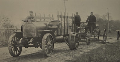 Construction was a natural fit for early trucks. And, symbiotically, so was building roads for the new-fangled vehicles to drive on. Here, an early truck pulls a grader. Note the ad hoc nature of the truck: right-hand steer, plush seating, a stake body and ag-tractor style iron wheels in the rear. That’s not the most ergonomic steering wheel arrangement you’ll ever see, either.