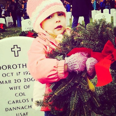 Volunteers ranged from uniformed service members and gray-haired veterans to the young girl pictured here. Photo by Carolyn Magner.