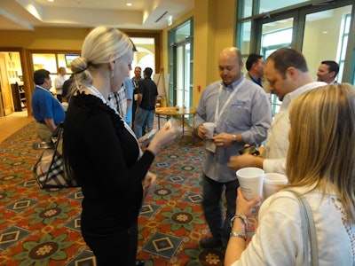Milana Yorichuk exchanges business cards with other members of the Alliance network at the Sylectus user conference