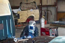 Warren Spears making repairs on an older F-150.