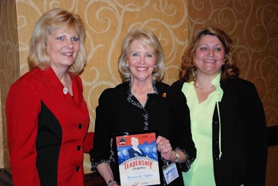 Award winner Marcia Taylor, center, is joined by Ellen Voie of Women in Trucking, left, and Navistar’s Jan Allman.