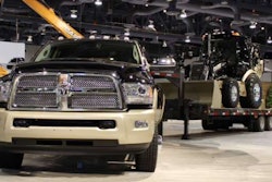 Ram Laramie Longhorn trailering color-matched-and-badged Case 580 Super N Wide Track backhoe loader.