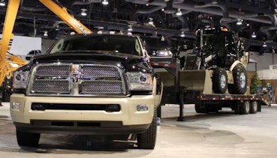 Ram Laramie Longhorn trailering color-matched-and-badged Case 580 Super N Wide Track backhoe loader.