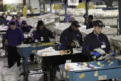 Team Members at FedEx Express Sort Packages for the Holidays