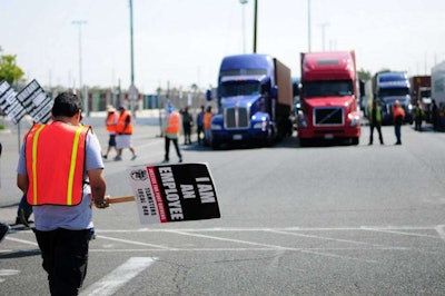 This photo is from a similar strike at the Port of LA earlier this year.