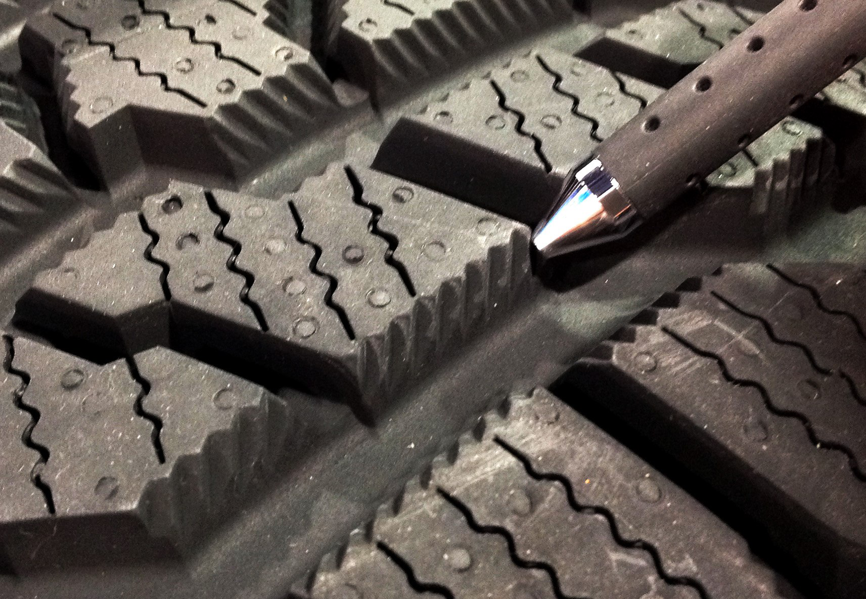 Special angled cuts going in opposite directions along the sides of the tread blocks are designed to trap snow for better traction.