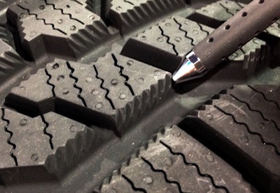 Special angled cuts going in opposite directions along the sides of the tread blocks are designed to trap snow for better traction.