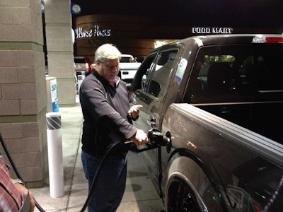 Cars.Com’s Editor-In-Chief, Patrick Olsen, refuels one of the dozen pickups during the 1/2-ton shootout.