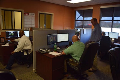 WTI’s dispatch wing is equipped with about 8 dispatch stations, each of them anchored with two big monitors for dispatchers to work with. The window on the back wall in this picture is where drivers can come talk to the dispatchers.