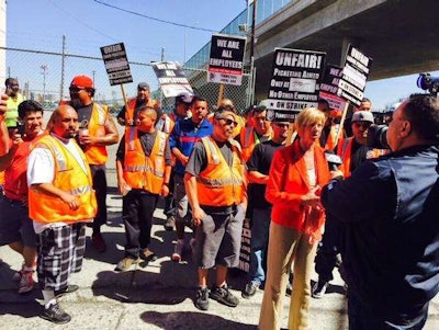 Some truckers picketed April 27 at the ports of Los Angeles and Long Beach, asking carriers to reclassify them as employees, not contractors.