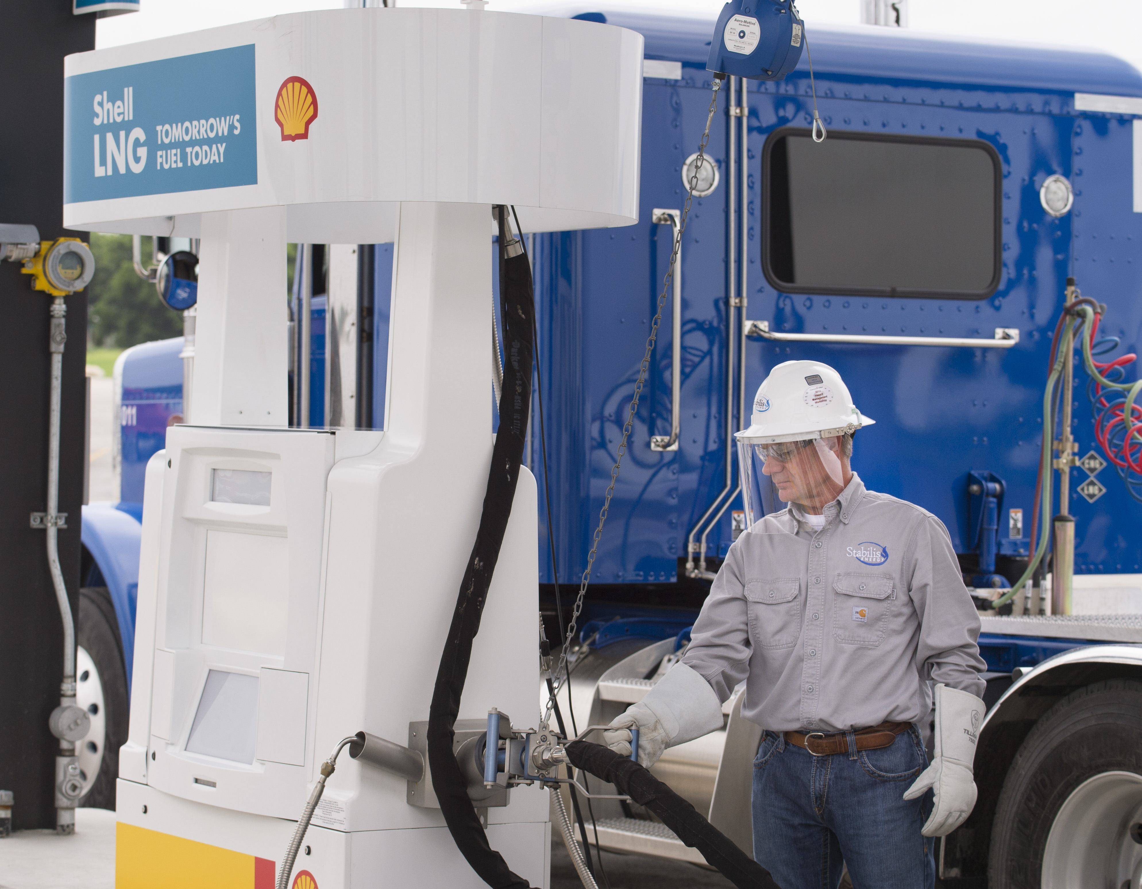 Truck driver fueling up at a Shell LNG pump