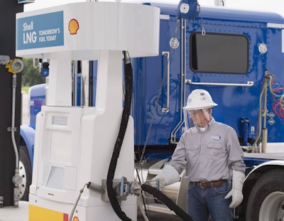 Truck driver fueling up at a Shell LNG pump