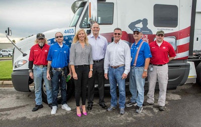 USA Truck presented four of its military veteran driving team members with personalized, military-themed tractors during a celebration Sept. 11 at the company’s corporate headquarters in Van Buren, Ark. Pictured from left are Michael Powell, U.S. Marines veteran; David Bell, U.S. Navy veteran; Shannon Newton, president of the Arkansas Trucking Association; Russell Overla, executive vice president of truckload operations for USA Truck; Tom Glaser, president & CEO of USA Truck; Robert Decker, U.S. Air Force veteran; and Jodie Yoder, U.S. Army veteran.