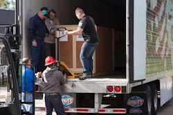 C.R. England driver Brent Sanger (front, far left inside trailer) and his wife, Carol, drove 2,000 miles to bring the “Victory from Within: The American Prisoner of War Experience,” to the Fort Douglas Military Museum in Salt Lake City on Oct. 19.