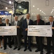 Michelin’s Mike Cain (3rd from left) and Volvo’s Göran Nyberg (4th from left) present awards to Ruan Transportation and Searcy Trucking.