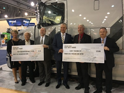 Michelin’s Mike Cain (3rd from left) and Volvo’s Göran Nyberg (4th from left) present awards to Ruan Transportation and Searcy Trucking.