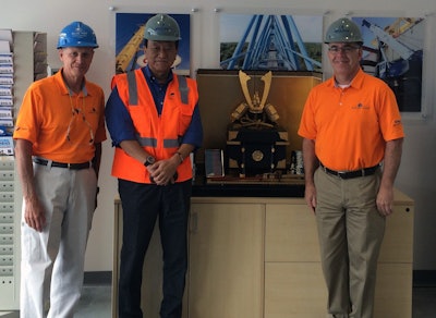 Blue Hat Crane accepts Kabuto helmet from Tadano America Corporation commemorating their new location and partnership. From left to right, Florian “Flo” Rothbrust, Blue Hat Crane senior vice president; Yo Kakinum, Tadano America president and COO; and Bob Jacquinot, Blue Hat Crane director of construction operations.