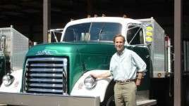 Gow Litzenburger pictured with one of 36 vintage fleet trucks still in operation at his Michigan landscape company.