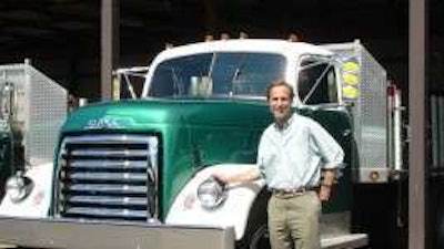 Gow Litzenburger pictured with one of 36 vintage fleet trucks still in operation at his Michigan landscape company.
