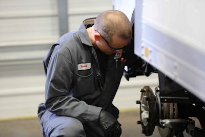 Ryder employee inspecting brakes on a truck