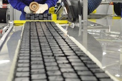 Michelin factory worker working on tire tread