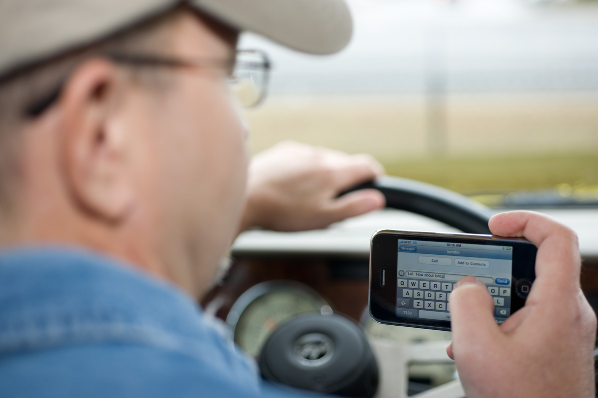Man behind the wheel while texting