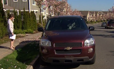 King County Councilmember Kathy Lambert stands next to a Chevrolet Uplander shortly before donating it to Life Enrichment Options. (Screen shot from king5.com.)