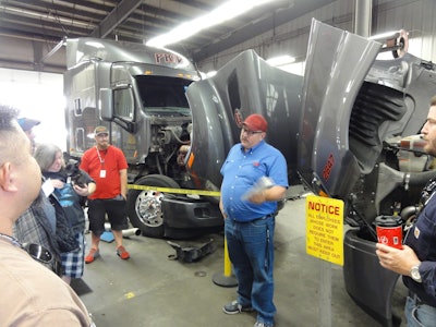 Rick Drigmore, shop manager of Pride Transport, explains the fleet’s maintenance procedures to new drivers on Wed., May 4.