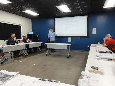 Gene Cardall, director of maintenance, talks to drivers about the amenities in their trucks.
